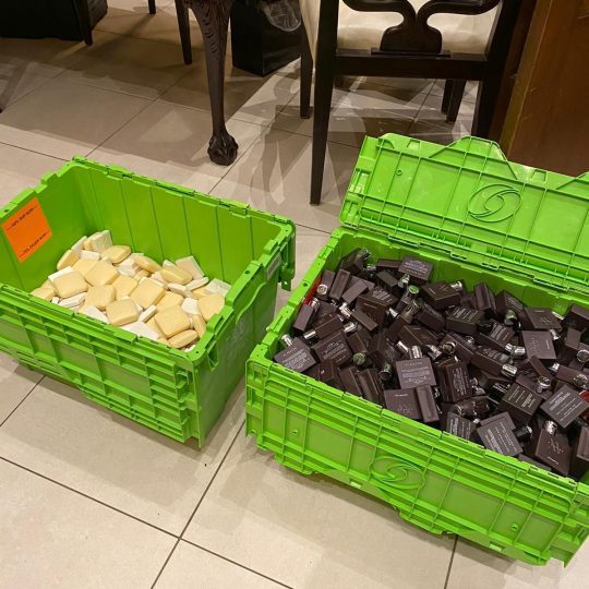 two green bins full of unused soap that the hotel donates
