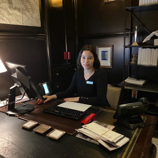 photo of our concierge team member sitting at the concierge desk